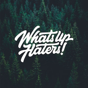 May include: White text on a dark green background reads "What's Up Haters!" The text is in a stylized font.