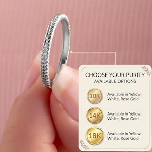 May include: A thin silver-toned metal ring featuring a continuous engraved leaf or wheat pattern along the outer band. An adjacent informational graphic displays the text CHOOSE YOUR PURITY AVAILABLE OPTIONS with 10K, 14K, and 18K gold icons.