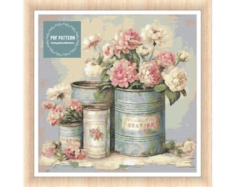 May include: A vintage-inspired cross stitch pattern featuring a bouquet of pink and white roses in three blue and white metal cans. The cans have labels with the text "Gratino" and "Le Petit Jardin".
