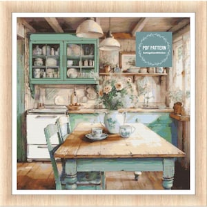 Op de afbeelding: Een vintage keuken met een groene kast, een wit fornuis en een houten tafel met een theepot en theekopjes. De keuken heeft een rustieke uitstraling met houten lambrisering en een raam met uitzicht op de buitenkant. De tekst "PDF PATTERN CottageCoreStitches" is zichtbaar in de rechterbovenhoek van de afbeelding.