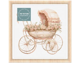 Op de afbeelding: Een vintage kinderwagen met een roze kap en witte wielen, versierd met roze rozen en groen. De kinderwagen staat op een witte achtergrond. PDF PATTERN CottageCoreStitches