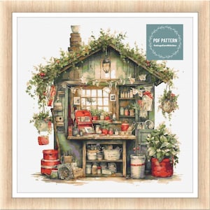 Può includere: Uno schema di punto croce di un capanno verde e marrone con un tetto rosso e una finestra bianca. Il capanno è pieno di attrezzi e forniture da giardinaggio. Lo schema è intitolato "PDF PATTERN CottageCoreStitches".