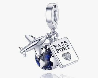 May include: Silver charm featuring a globe with blue and black accents, a small airplane, and a passport with the word "PASSPORT" printed on it. The charm has a heart-shaped design on the passport.