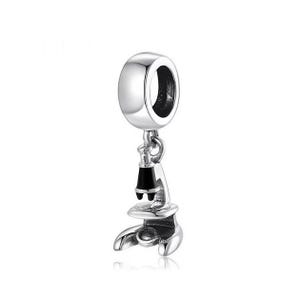 May include: Silver charm featuring a detailed microscope with a black lens. The charm is designed to fit on a bracelet or necklace.
