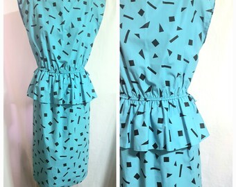 Fabulous 1980s aqua blue statement dress with geometric abstract print. Size Small.  Dress made in Australia on "Changing Scene" label.