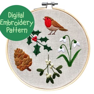 May include: A digital embroidery pattern displayed in a wooden hoop. The design features a robin, holly, snowdrops, mistletoe, and a pinecone. The text "Digital Embroidery Pattern" is in a green circle.