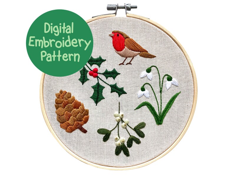 May include: A digital embroidery pattern displayed in a wooden hoop. The design features a robin, holly, snowdrops, mistletoe, and a pinecone. The text "Digital Embroidery Pattern" is in a green circle.