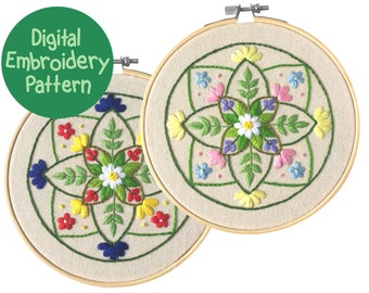 May include: Two embroidery hoops with floral patterns. Each hoop features a central flower design with colorful petals in red, yellow, blue, and pink, surrounded by green leaves and stems. The text "Digital Embroidery Pattern" is in a green circle.