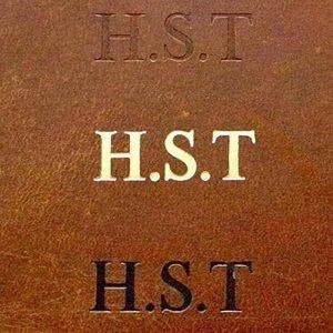 May include: Close-up of a brown leather surface with the initials "H.S.T." embossed in three different styles: debossed, white, and black. The leather has a textured appearance.