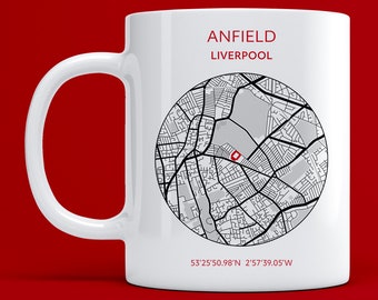 May include: White ceramic mug with a black and white map of Anfield, Liverpool, England. The mug has the text "Anfield Liverpool" and the coordinates "53°25'50.98"N 2°57'39.05"W" printed on it.