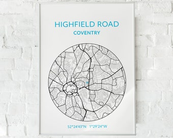 May include: A framed print featuring a detailed black and white map of Highfield Road, Coventry, set within a circular design. The text "HIGHFIELD ROAD COVENTRY" is displayed in blue, along with the coordinates 52°24'43"N 1°29'24"W. The print is mounted on a white background.
