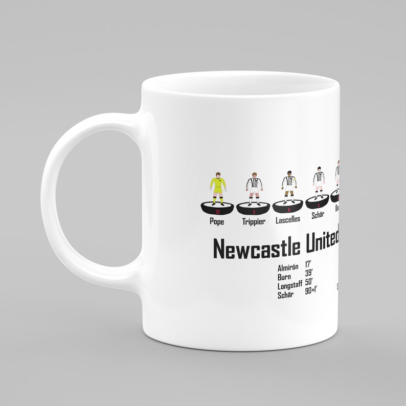 May include: White ceramic mug with a black and white illustration of a soccer team lineup. The text "Newcastle United" is printed below the lineup. The names of the players and their jersey numbers are listed below the lineup.