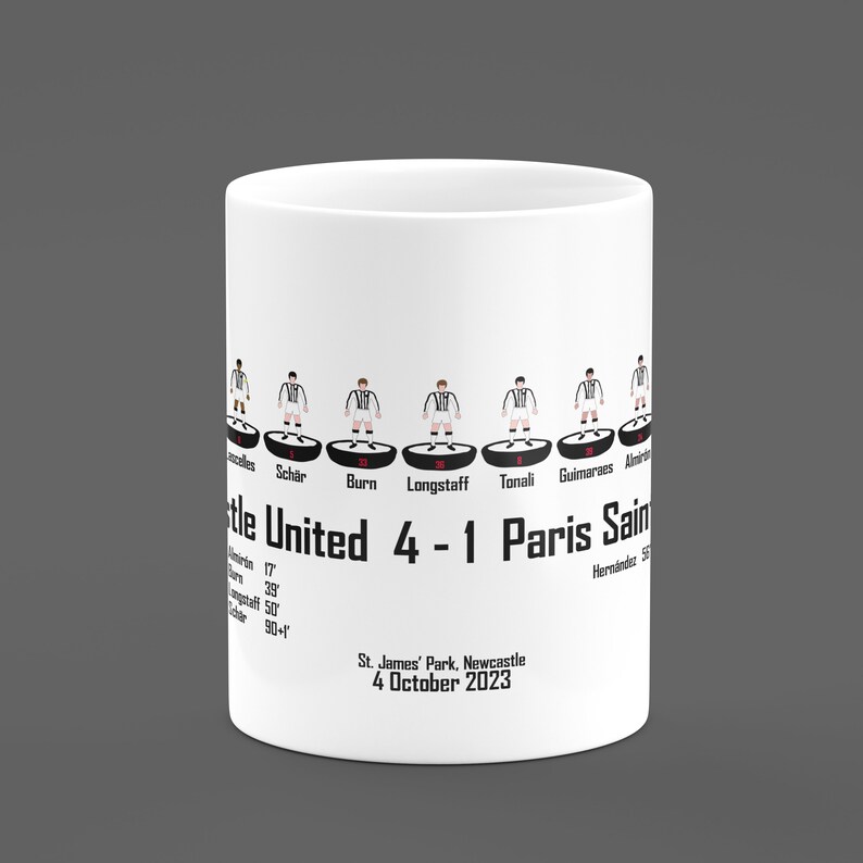 May include: White ceramic mug with a black and white illustration of a soccer lineup. The text "Newcastle United 4-1 Paris Saint" is printed on the mug. The date "4 October 2023" and the location "St. James' Park, Newcastle" are also printed on the mug.