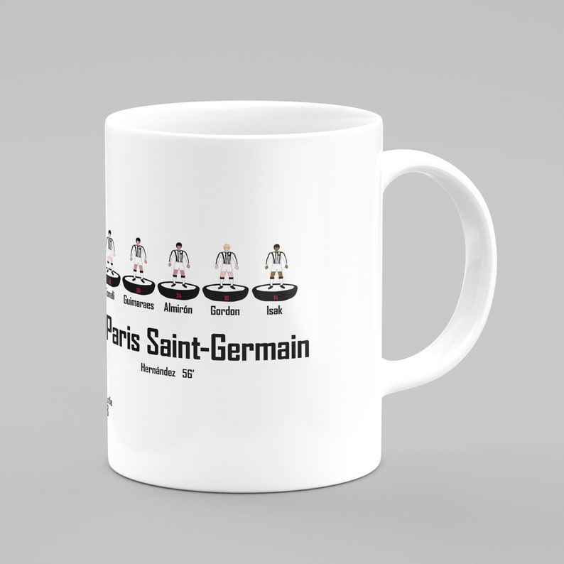May include: White ceramic mug with a black and white illustration of a soccer team lineup. The team name "Paris Saint-Germain" is printed below the lineup. The players are wearing black and white uniforms.