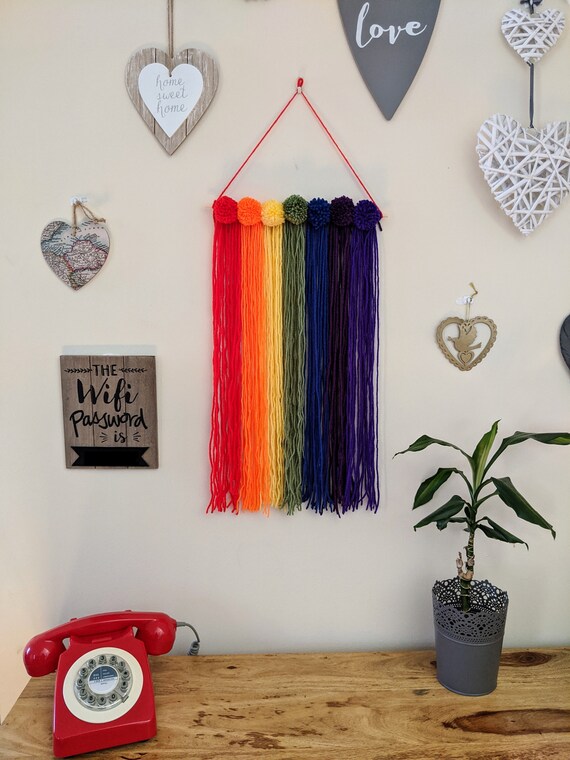Rainbow Pom Pom Wall Hanging, Macrame Rainbow Nursery Wall Decoration. Rainbow Pom Pom Wall Hanging, Macrame Rainbow Nursery Wall Decoration.