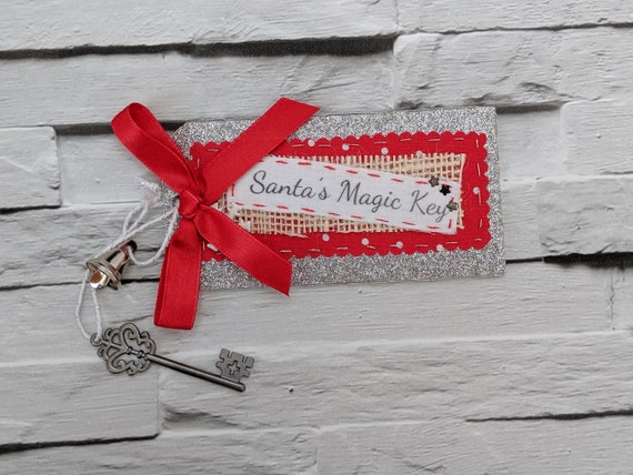 Santa's Magic Key. Magic Key for Santa Claus with a Silver glitter tag and red ribbon. Santa's Magic Key. Magic Key for Santa Claus with a Silver glitter tag and red ribbon.