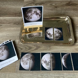 May include: A set of eight black and white moon phase cards with the text "waning gibbous" and "full moon".