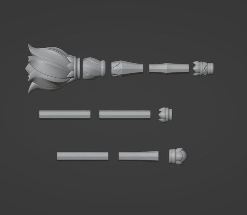 May include: A 3D printed model of a decorative scepter, broken down into its individual parts. The scepter features a lotus flower design at the top and a pointed tip at the bottom.