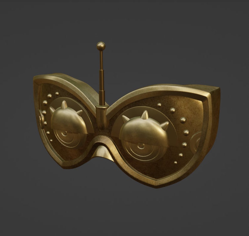 Op de afbeelding: Een gouden bril met een enkele antenne bovenop. De bril heeft een rond, metalen ontwerp met een getextureerd oppervlak.