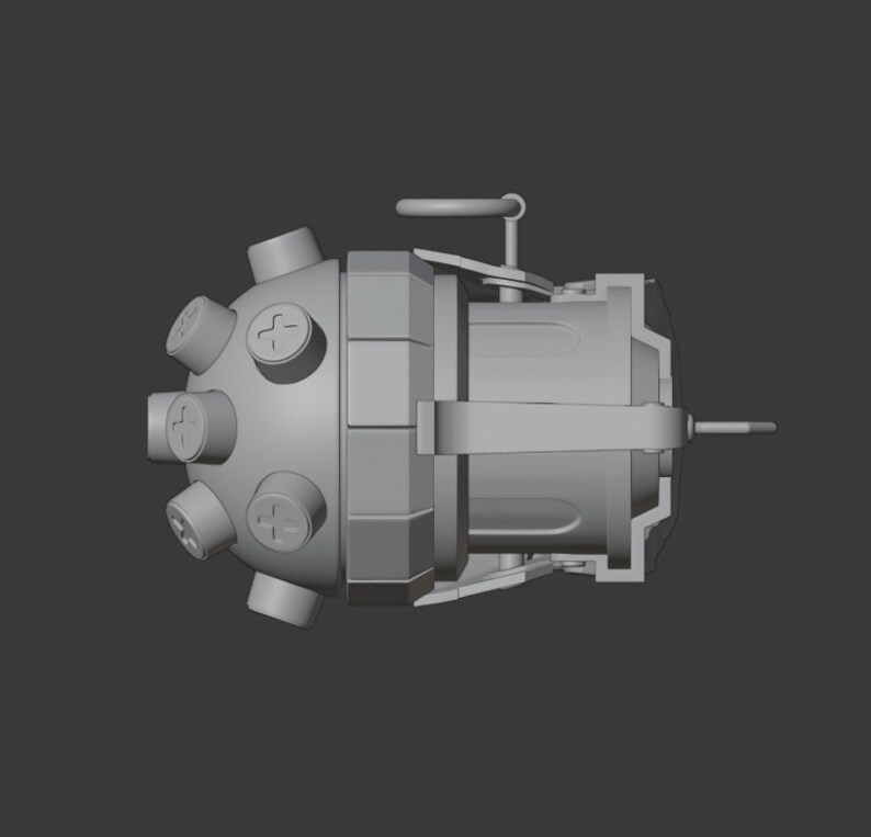 May include: A gray metal grenade with a round, spiky top and a lever on the side. The grenade has a textured surface and a small ring on the top.