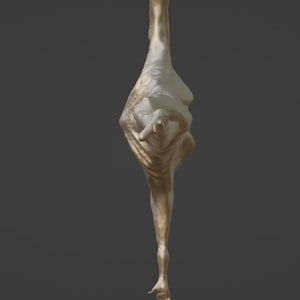 May include: A gold-colored abstract sculpture of a human figure in a contorted pose.