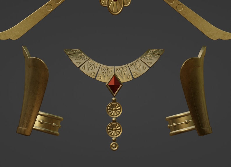 May include: A gold-toned jewelry set consisting of a wide collar necklace with a central red diamond-shaped stone and three dangling circular pendants, two matching arm cuffs, and a curved headpiece with a central floral element.