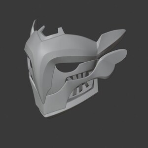 May include: A gray 3D printed mask with a sharp, angular design. The mask has a pointed nose, a wide mouth with teeth, and two large, wing-like protrusions on the sides.