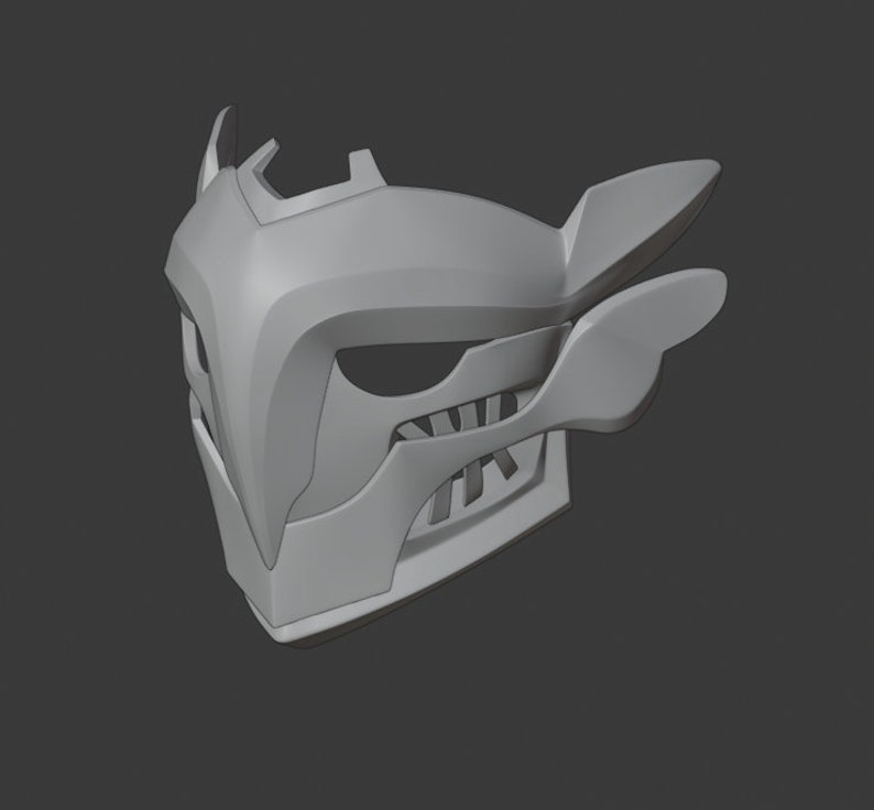 May include: A gray 3D printed mask with a sharp, angular design. The mask has a pointed nose, a wide mouth with teeth, and two large, wing-like protrusions on the sides.