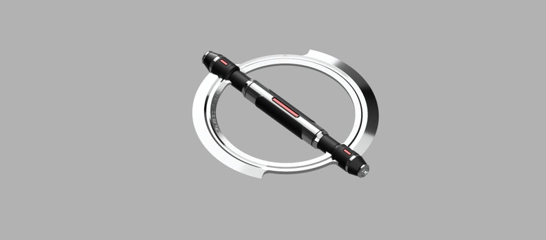 May include: A black and silver tool with a red accent. The tool is shaped like a long cylinder with a circular ring at one end. The tool is lying on a gray surface.