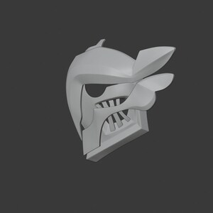 May include: A white 3D printed helmet with a sharp, angular design. The helmet has a pointed top and a face mask with a series of teeth.