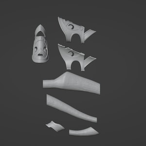 May include: A set of 3D printed parts for a model of a sandal. The parts are in various shapes and sizes, including a sole, a strap, and a buckle.