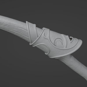 May include: A close-up of a wooden bow with a decorative, ornate, gray metal handguard. The handguard has a swirling, intricate design.