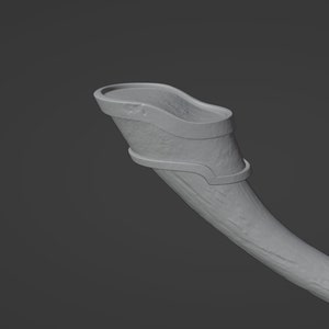 May include: A gray, ceramic drinking horn with a decorative metal band around the top.