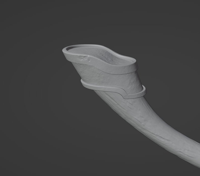 May include: A gray, ceramic drinking horn with a decorative metal band around the top.