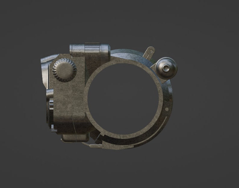 May include: A silver-colored metal device with a round opening and a knob on the side. The device has a textured surface and appears to be a vintage camera lens.