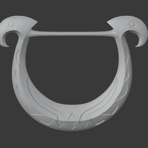 May include: A light grey, U-shaped decorative object with bird-like heads at each end. The object has a curved design with etched details, and a straight bar connecting the bird heads. The background is a solid grey.
