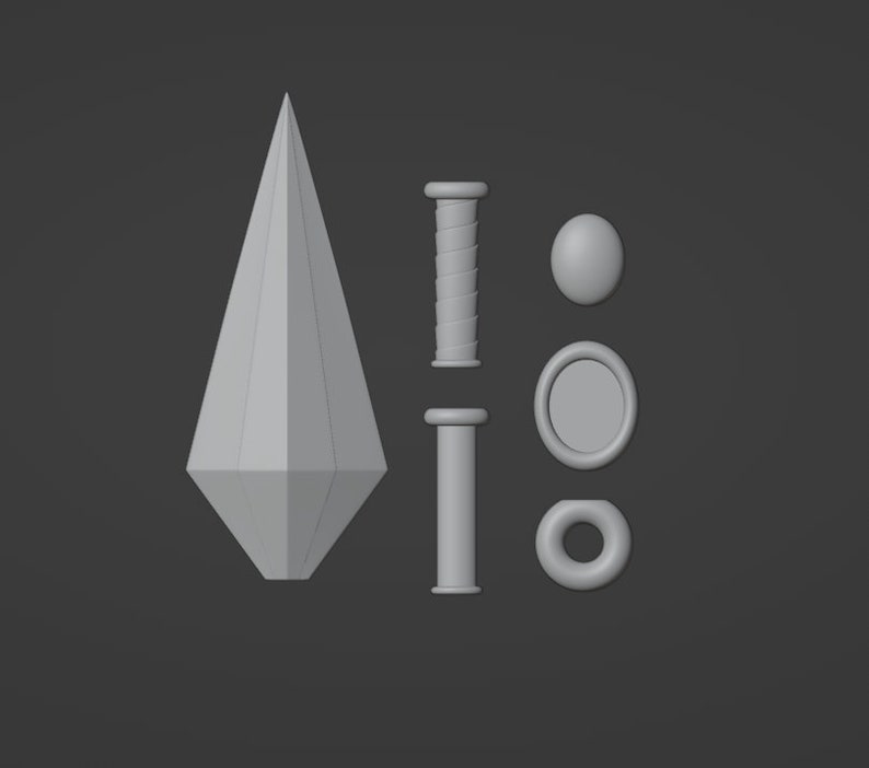 Puede incluir: Un conjunto de cinco objetos impresos en 3D, que incluyen una lanza puntiaguda, dos piezas cil&iacute;ndricas, un anillo y un disco redondo.
