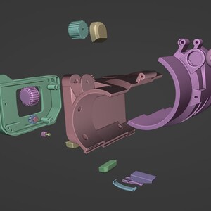 May include: A disassembled 3D printed model of a camera. The model is made up of 11 pieces, including a body, lens, and various gears. The pieces are in various shades of purple, green, and brown.