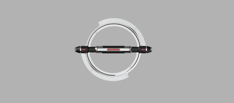 May include: A silver and black circular object with a red line across the center. The object is suspended in the air and appears to be rotating.