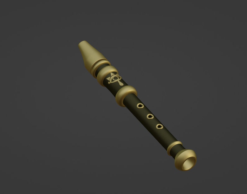 May include: A gold and black flute with a decorative design. The flute has six holes and a gold mouthpiece.