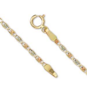 A close-up of a 14K tri-color Valentino chain laid on a plain background, showcasing its intricate links in rose, white, and yellow gold.
