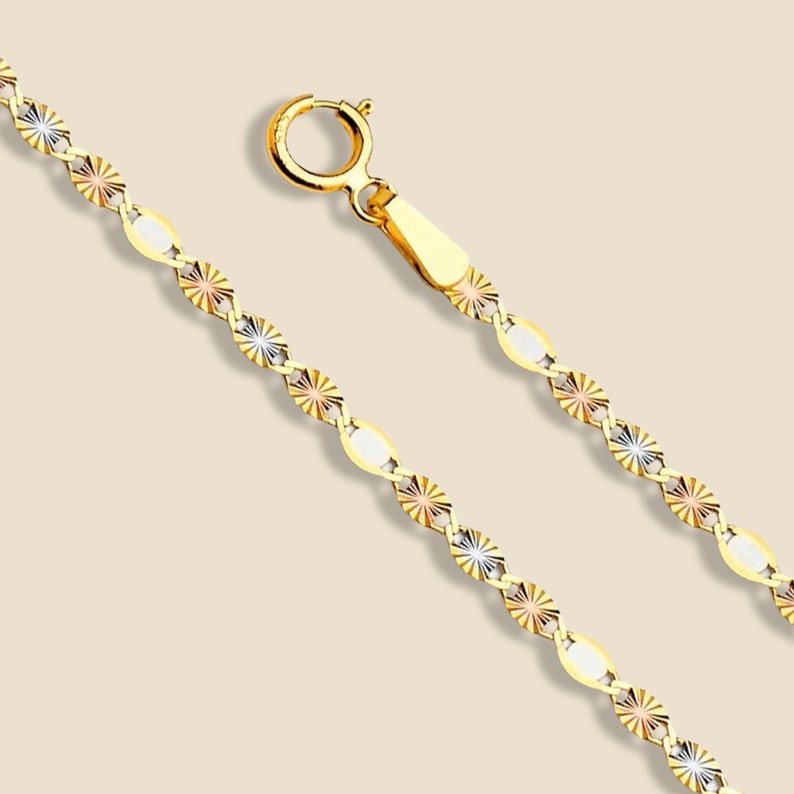 A stunning 14K solid gold Valentino chain necklace displayed on a clean, plain background. This elegant 2mm chain features a polished finish, reflecting light beautifully. Crafted in Italy, the delicate yet durable design makes it perfect for layering or wearing solo. Available in lengths from 16 to 24 inches, with a secure spring ring clasp for a comfortable fit.