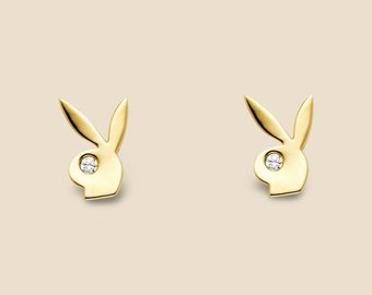 May include: A pair of gold-tone stud earrings featuring a small diamond in the centre of each bunny head design.