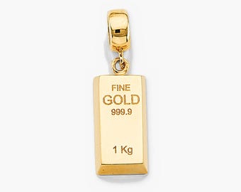 May include: A gold-colored metal pendant shaped like a rectangular bullion bar. The front surface is engraved with the text FINE GOLD, 999.9, and 1 Kg. The pendant features a polished finish and includes a small attached bail at the top.