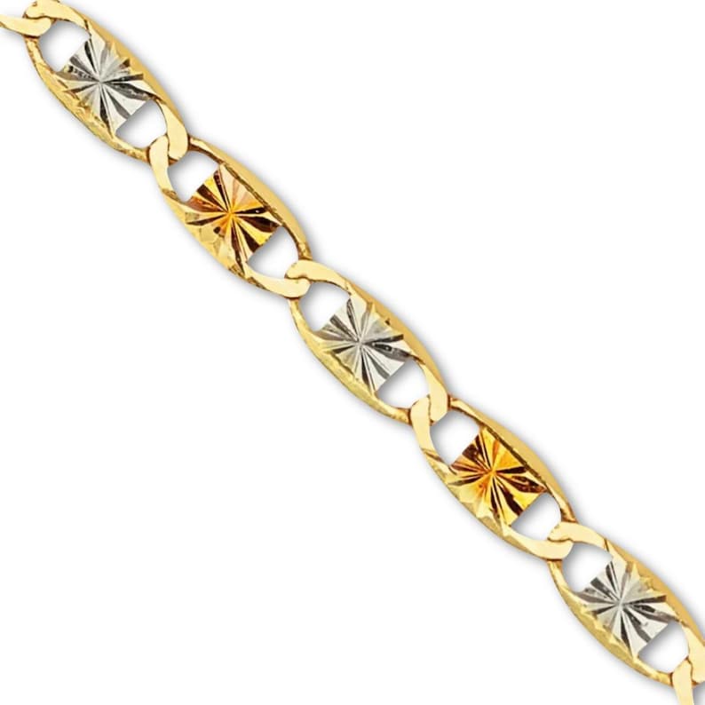 A close-up of a 14K tri-color Valentino chain laid on a plain background, showcasing its intricate links in rose, white, and yellow gold.