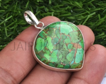 May include: A green and copper turquoise pendant set in sterling silver. The pendant is shaped like a teardrop and has a smooth, polished finish.