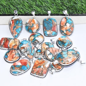 May include: A collection of 12 turquoise and coral gemstone pendants with silver settings. The pendants are various shapes and sizes, including oval, teardrop, and rectangular.