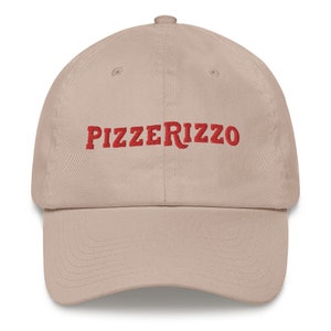 May include: A beige baseball cap with the text "Pizzerizzo" embroidered in red.