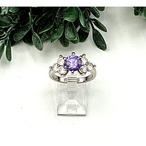 Silver Tone Ring With Purple & Clear Flanked Cubic Zirconia Stones
