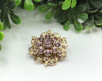 Vintage brooch gold tone with lavender rhinestones flower shape